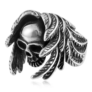 Close-up detail of vintage punk skull and feather stainless steel ring for men, gothic style.