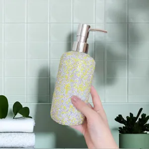 Close-up detail of a luxury rhinestone soap dispenser bottle for bathroom lotion and shampoo.