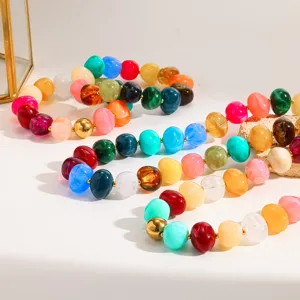 Colorful acrylic beaded necklace detail with gold spacer beads for vacation and summer fashion style.