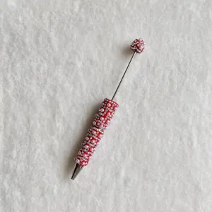 Rhinestone pearl beaded pen detail shot, creative DIY decorative stick with sparkly crystals.