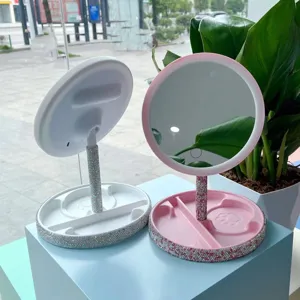 LED desktop makeup mirror, pink and white vanity mirror with rhinestones and lights. Detail view.
