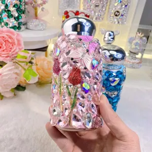 Rhinestone thermal water bottle detail, pink bling insulated cup with butterfly and tulip floral design.