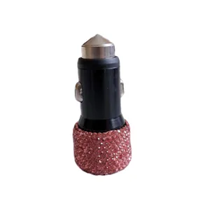Detail view of sparkling pink rhinestone car charger adapter with metal tip and compact design.