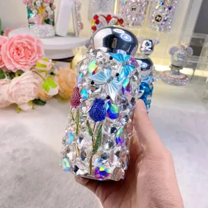 Detailed view of the luxury rhinestone vacuum flask, sparkling crystal butterfly and tulip design.