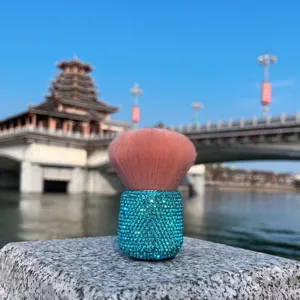 Detailed view of fluffy mushroom makeup brush featuring a stunning sparkling rhinestone base.