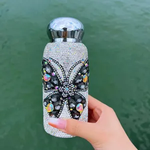Sparkling rhinestone butterfly crystal detail view of insulated pocket cup for outdoor travel.