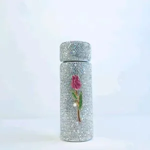Close-up detail of a mini rhinestone insulated pocket water bottle with sparkling crystals and tulip motif.