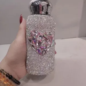 Detailed shot of sparkling rhinestone insulated thermos bottle with cute crystal heart design.