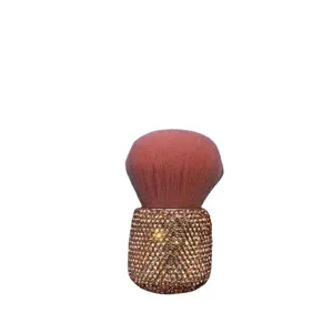 Large fluffy mushroom makeup brush with sparkling rhinestone handle for soft powder application.