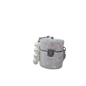 Sparkling rhinestone mini cylindrical crossbody bag with pearl handle and metal chain for women.