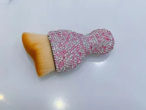 Close-up detail view of sparkling rhinestone car interior dust cleaning brush with soft bristles.