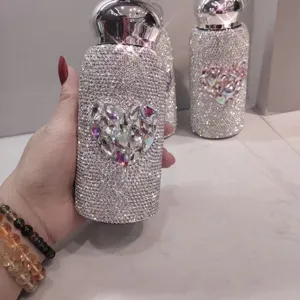Rhinestone thermos cup detail showing sparkling crystal heart design, portable and luxury.