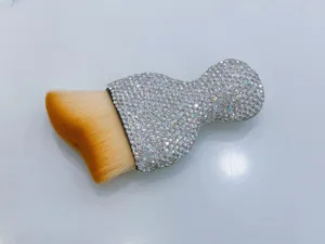 Close-up of a sparkling rhinestone car interior cleaning brush with soft bristles for dust.