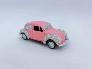 Detailed shot of a pink rhinestone classic beetle car model, perfect for interior decor.