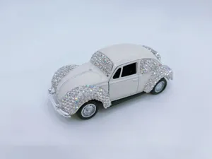 Detail view of a vintage rhinestone car model, sparkling crystal ornament for car dashboard.