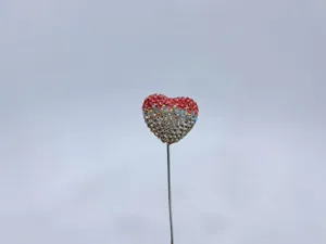 Close-up detail shot of the sparkling rhinestone heart balloon car interior ornament pin.