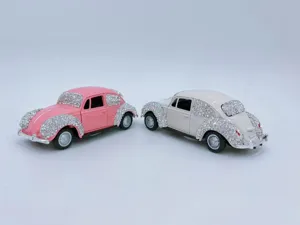 Detailed view of rhinestone-encrusted classic beetle alloy car models, pink and white options.