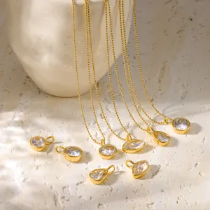 Detail view of minimalist gold bead chain necklaces and sparkling geometric zircon pendants.
