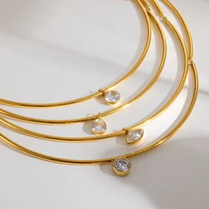 Collier rigide multicouche doré avec des pendentifs en zircone cubique, joli détail.