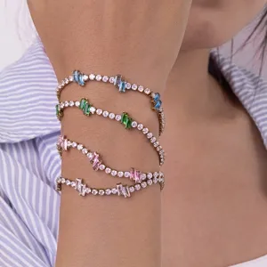 Close-up detail of multi-strand gold plated tennis bracelet featuring colorful zircon stones.