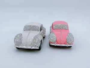 Close-up of rhinestone classic car model, crystal encrusted alloy interior ornament detail.