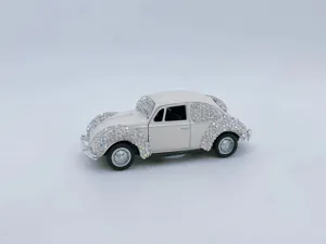 Detailed close-up view of the sparkling rhinestone vintage car ornament with alloy body decor.