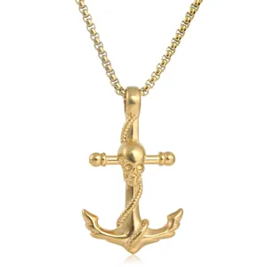 Close-up view of the gold-tone stainless steel skull anchor pendant and chain link detail.