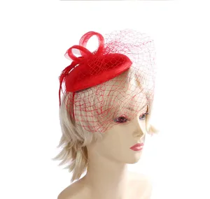 Detail view of elegant red mesh fascinator hat with veil, perfect for vintage bridal events.