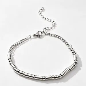 Closeup detail of the stainless steel Morse code beaded bracelet showing texture and links.