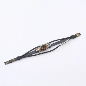 Vintage multi-layer braided leather zodiac charm bracelet detail shot with metal tubes.