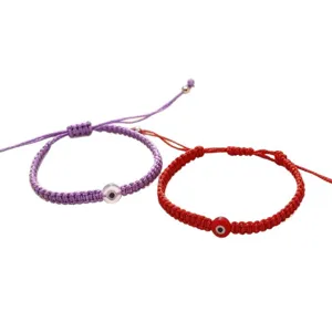 Handmade evil eye braided rope adjustable bracelets set in purple and red colors.