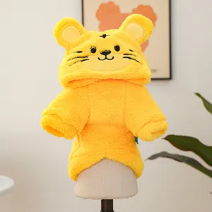 Close-up detail of cute yellow plush pet hoodie costume with animal tiger face design on stand.