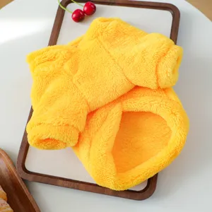 Cute yellow pet plush clothing for small dogs, soft and warm winter pet costume detail view.
