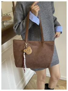 Spacious brown tote bag with cute bear keychain for women commuter stylish daily use.