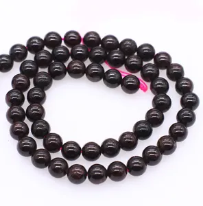 Natural garnet gemstone beads detail shot, deep red round crystal beads for DIY jewelry making.