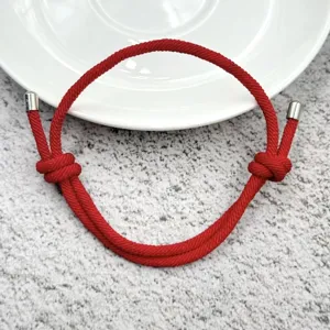 Handmade woven red rope adjustable bracelet for couples, minimalist style daily jewelry piece.