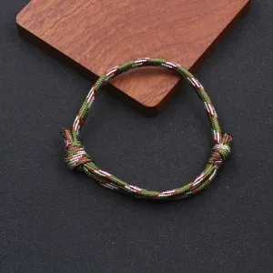 Handmade adjustable nylon paracord bracelet detail, minimalist unisex braided rope style.
