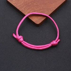Closeup detail of the pink nylon paracord braided adjustable handmade bracelet, simple style.