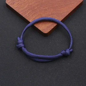Detailed view of the dark blue handmade nylon paracord bracelet with adjustable knot.