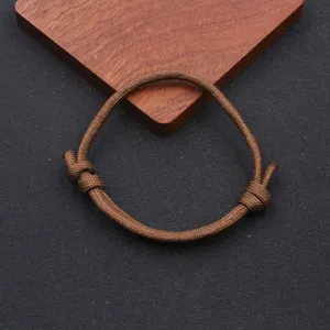 Close-up detail of the brown paracord adjustable handmade braided bracelet showing smooth texture.