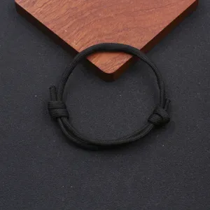 Close-up detail of a minimalist black paracord adjustable handmade braided bracelet for daily wear.