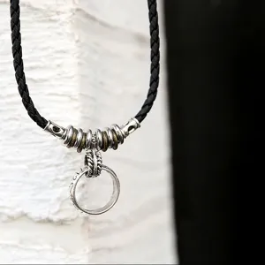 Retro Herren Halskette aus schwarzem Lederimitat mit Metallringen und Anhänger im Vintage Stil.