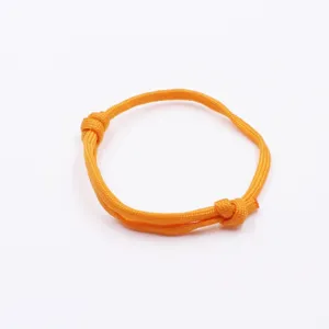 Detailed close-up view of vibrant orange paracord nautical nylon braided adjustable bracelet.