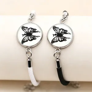 Paar geflochtene Partnerarmbänder mit schwarzem Schmetterling Glas Cabochon Edelstahl.