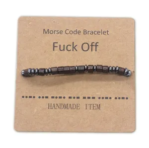 Detail view of the handmade Morse code beaded bracelet on a Kraft paper card, unique design.