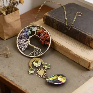 Tree of life crystal suncatcher detail showing wire-wrapped colorful healing stones and prism.