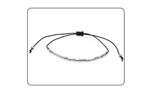 Detail shot of the Morse code beaded braided bracelet, showing metallic beads and string.