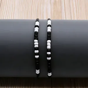 Black and white seed bead Morse code couple bracelet set, creative braided rope design main view display.
