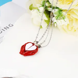 Detailed close-up of the magnetic couple heart necklace featuring red hands holding split hearts.