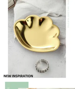 Exquisite gold stainless steel shell jewelry tray detail shot, elegant desktop storage accessory.